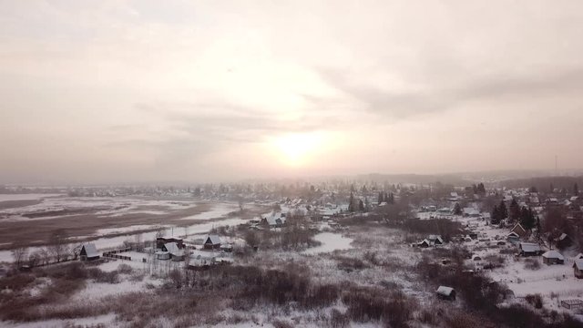 Beautiful winter landscape. Siberian village in the cold. Sunrise. Industrial landscape.