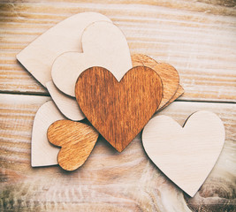 Lots of wooden hearts on the wooden table