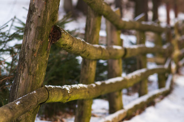wooden old fence under the snow. selective focus. perspective.