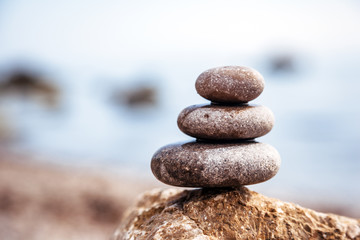 Fototapeta na wymiar Stones balance, pebbles stack over blue sea. Picturesque and gorgeous scene.