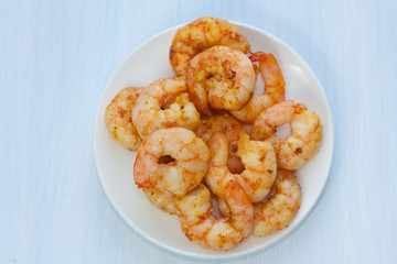 Plate of delicious prawns. Fried prawns with curry, pepper and salt.