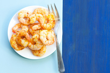Plate of delicious prawns. Fried prawns with curry, pepper and salt.