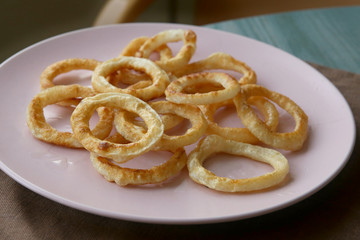 Fried squid rings in plate. Snack calamari rings.