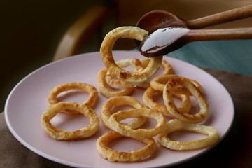 Fried squid rings in plate. Snack calamari rings.