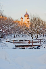 Fototapeta na wymiar white stone church in the winter on the river bank