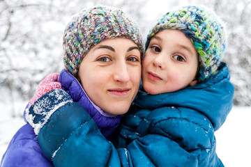 Mother hugs the child.