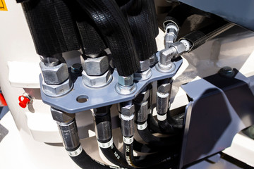 Fototapeta premium Close up of pipe system of hydraulic valves in agricultural machinery