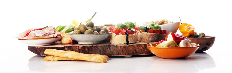 Italian antipasti wine snacks set. Cheese variety, Mediterranean olives, pickles, Prosciutto di Parma, tomatoes, artichokes - obrazy, fototapety, plakaty
