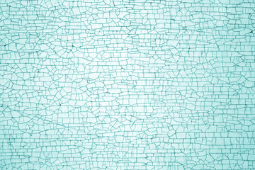 Cracks on metal colored texture in cyan tone.