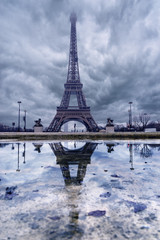Eiffel tower in clouds before storm