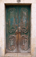Fototapeta na wymiar Old Portuguese front door, entrance with ornaments, antique