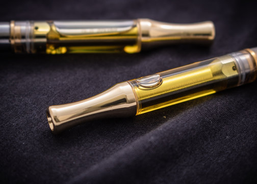 THC/CBD Cannabis Oil & Terpenes Filled Cartridges Isolated Up Close On Black