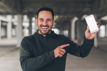 Man in sportswear using phone.