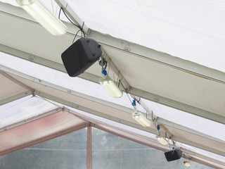speakers and neon lights on the ceiling of  tensile structure