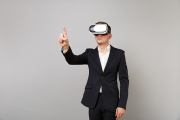 Young business man in suit looking in headset touch something like push click on button and...
