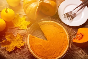 Tasty pumpkin pie on background