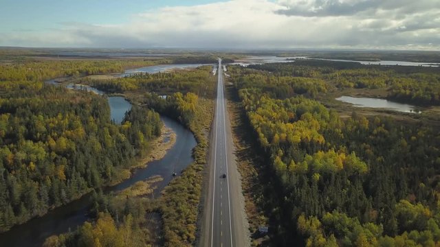 Aerial panoramic view of a scenic road during a beautiful sunny day in the Autumn. Taken near Grand Falls-Windsor, Newfoundland, Canada.