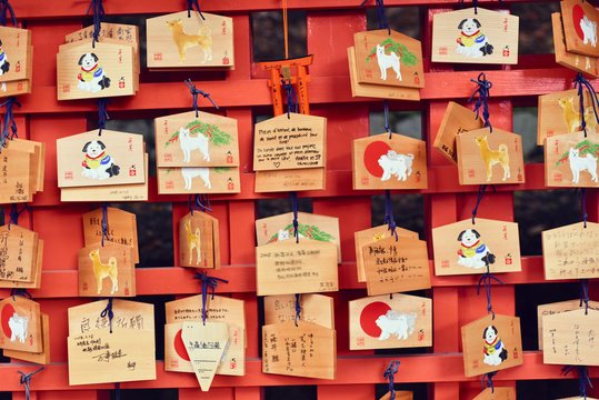 Wishes tied to nails on wooden board at temple