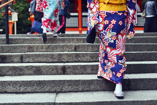 Low section of women walking up on stair
