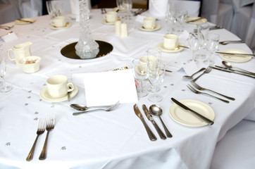 An empty blank paper table card name plate sign on a wedding table,  shot with a shallow depth of field. perfect for placing names in composite designs.