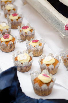 Beautiful inviting Sponge and cream cup cakes with a shallow depth of field, photographed on a table.