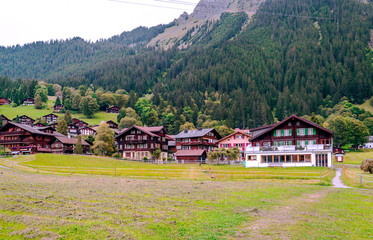 Fototapeta na wymiar Wooden houses in the Murren mountains in Switzerland on a cloudy day