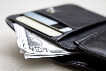  men's black wallet money in cash wooden white vintage background.