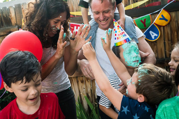 Family celebrating birthday outdoors