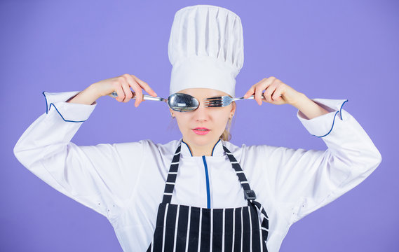 Culinary school concept. Woman professional chef hold utensil spoon fork having fun. Time to eat. Appetite and taste. Traditional culinary. Professional cook of culinary school. Culinary arts academy