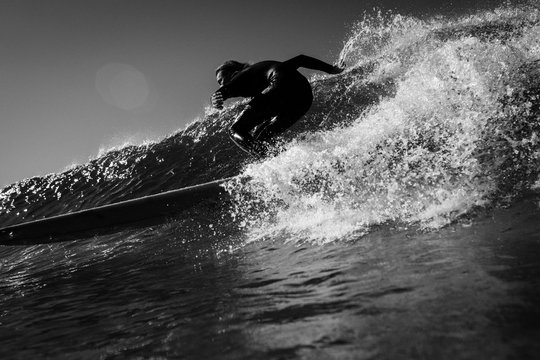 Surfer surfing in sea against sky