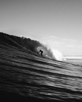 Surfer surfing in sea against clear sky