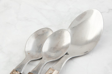 Spoons on white gray background.