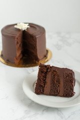 Slice of chocolate cake on marble countertop