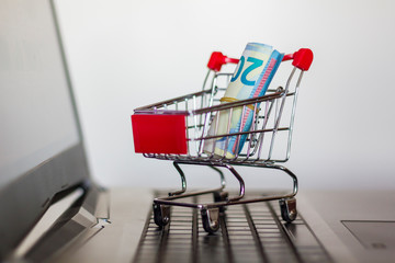 Shopping cart on a laptop keyboard. Online shopping concept