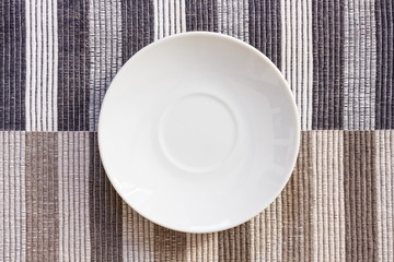 Small white dish on a tablecloth