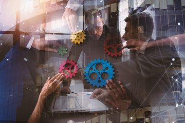 Business team connect pieces of gears. Teamwork, partnership and integration concept. Double exposure