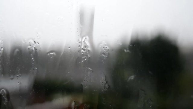 Raindrops on the window after a big rainstorm on a dark midday winter