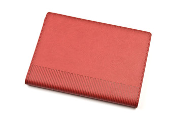 Red notebook on white background.	