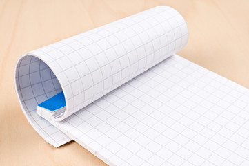 Notepad on wooden table.	