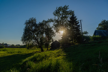 Fototapeta na wymiar Backlit landscape with rural view