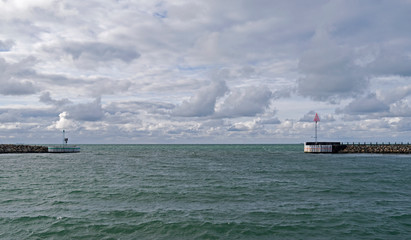 Laesoe / Denmark: View through the port entrance of Vesteroe Havn to the north on a windy day in April