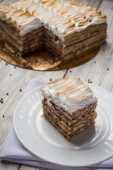 shortbread cake with cream with condensed milk, chocolate and nuts