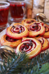 Obraz na płótnie Canvas Sweet cranberry roll buns with chocolate drops and two cups of cranberry fruit drink