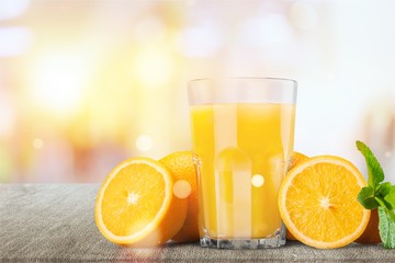 Orange juice and slices of orange on background