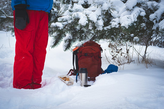 Traveler relaxing and drinking coffee from thermos