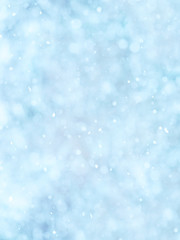 Snowing. Vertical abstract soft natural winter background,  falling snowflakes. Light blue tone