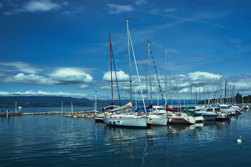 Fototapeta na wymiar Yachts in a harbor in Tholon on Lake Geneva in France.