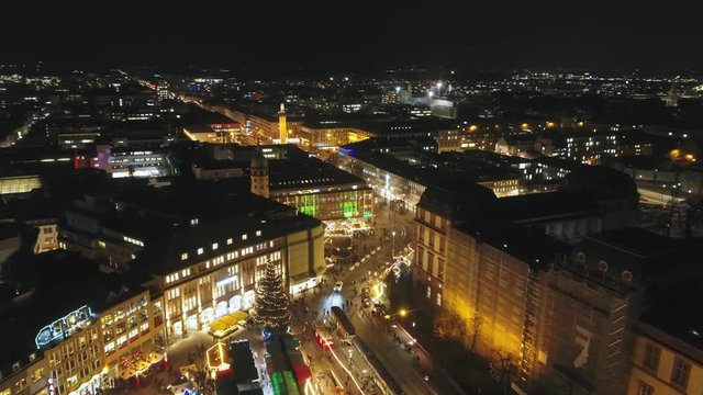 Aerial view: Darmstadt at night. Flying over the Central square with the old Town Hall
