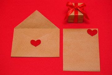 Valentine's Day. The 14th of February. An envelope, a sheet of paper and a gift, ready to be sent to your loved one.
