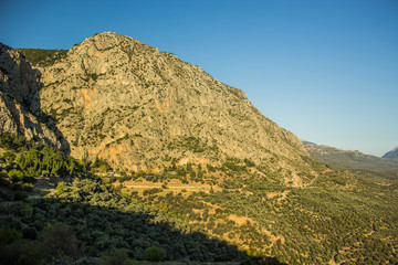 steep bare rock with forest at the foot of the mountain scenery landscape in sun rise morning time